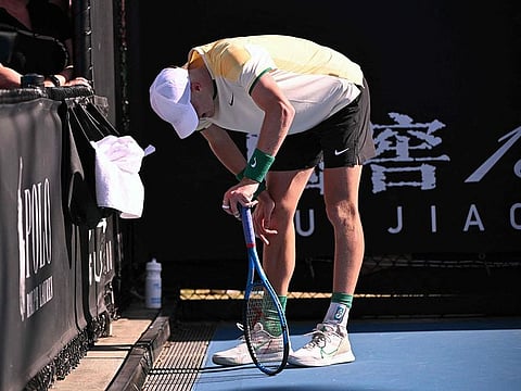 Britain's Jack Draper reacts in pain with an abdomen injury after winning his men's singles match against USA's Marcos Giron on day three of the Australian Open tennis tournament in Melbourne on January 16, 2024.  