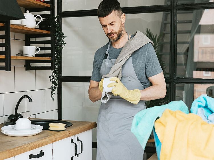 Person scrubbing mugs