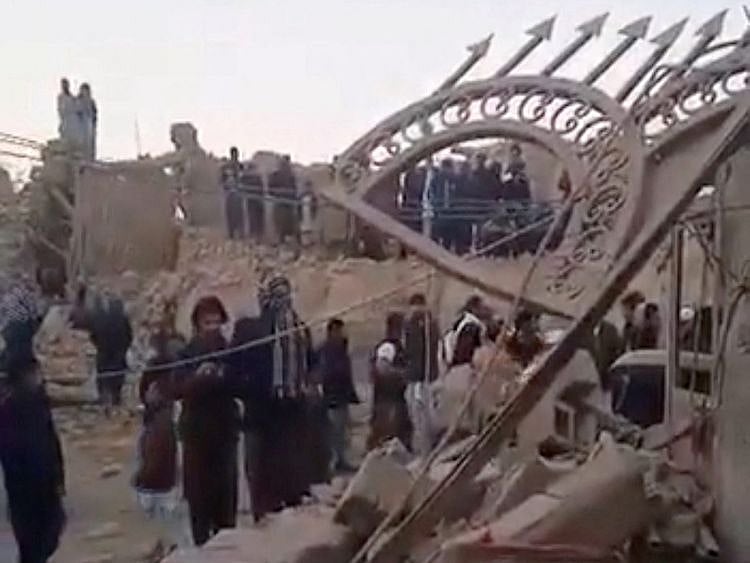 People gather near rubble in the aftermath of Pakistan's military strike on an Iranian village near Saravan, Sistan-Balochistan Province, in Iran, on January 18, 2024.