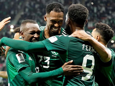 Saudi Arabia's midfielder Mohamed Kanno celebrates with teammates after scoring their first goal during the Qatar 2023 AFC Asian Cup Group F match against Kyrgyzstan at the Ahmad Bin Ali Stadium in Al Rayyan on Sunday.