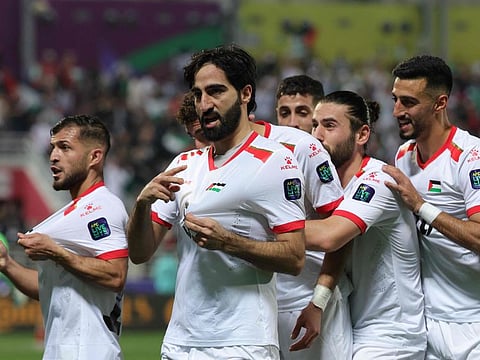 Palestine's players celebrate their second goal during the Qatar 2023 AFC Asian Cup Group C match against Hong Kong at the Abdullah Bin Khalifa Stadium in Doha on Tuesday.
