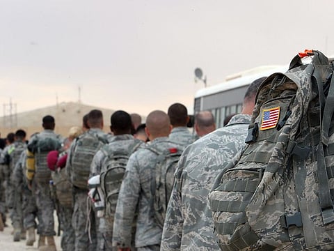 File photo: US army soldiers queue to board a plane to begin their journey home out of Iraq from the Al Asad Air Base west the capital Baghdad.   