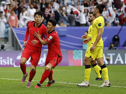 South Korea's Son Heung-min celebrates scoring their third goal with Hwang Hee-chan during the AFC Asian Cup Group E match at Al Janoub Stadium, Al Wakrah, Qatar on Thursday.