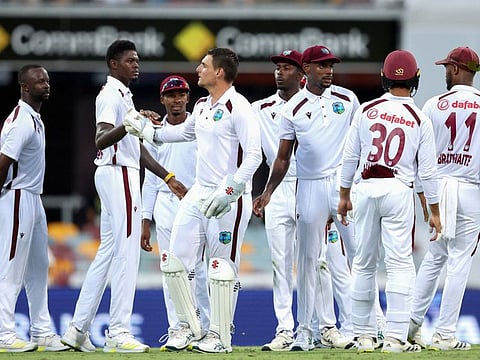 West Indian players celebrate a wicket during the second day of the second Test against Australia in Brisbane on Friday.