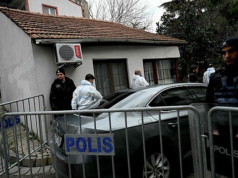 Turkish forensic police officers walk near Santa Maria church after an attack, in Istanbul, on January 28, 2024.  