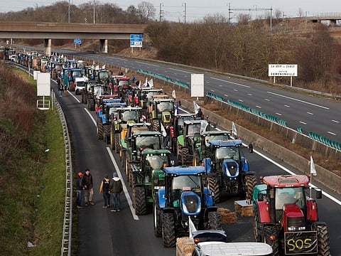 Tractors and other vehicles queue on the A1 highway during a protest over price pressures, taxes and green regulation, grievances shared by farmers across Europe, in Chennevieres-les-Louvres, near Paris, France, January 29, 2024.  
