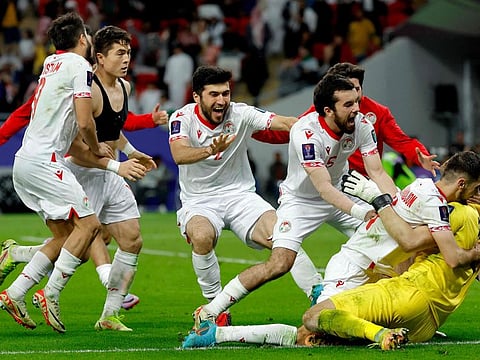 Tajikistan's players celebrate with their goalkeeper Rustam Yatimov after their win over UAE in the Qatar 2023 AFC Asian Cup round of 16 match at Ahmad Bin Ali Stadium in Al Rayyan, west of Doha, on January 28.