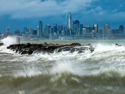 Waves crash over a breakwater in Alameda, California.