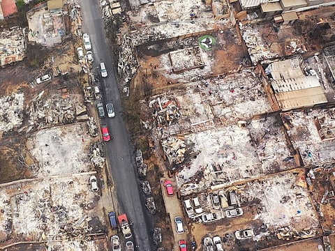 Aerial view of burned homes and vehicles after a forest fire in Quilpue, Viña del Mar, Chile.