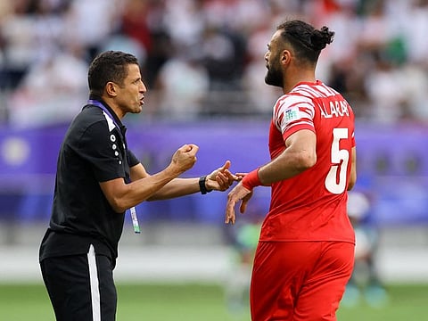 Jordan's Yazan Al Arab celebrates scoring their second goal with coach Hussein Ammouta. Jordan have held South Korea 2-2 in the group phase