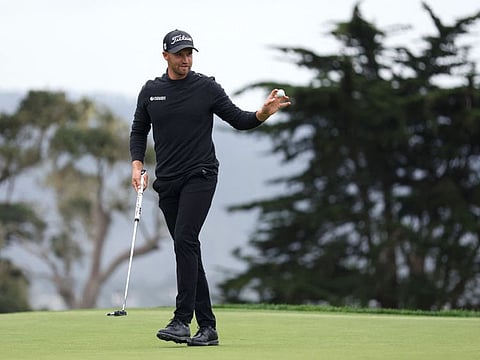 Wyndham Clark of the United States acknowledges the crowd after a putt on the 14th green during the AT&T Pebble Beach Pro-Am at Pebble Beach Golf Links.