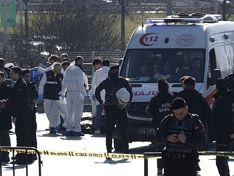 Forensic experts examine the area after a shooting outside the Caglayan courthouse in Istanbul on February 6, 2024.  