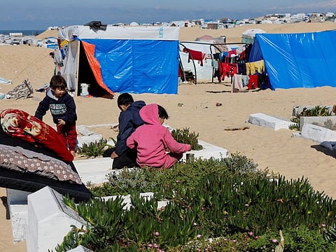 Displaced Palestinian children, who fled their houses due to Israeli strikes, play in a cemetery where they shelter, amid the ongoing conflict between Israel and Hamas, in Rafah in the southern Gaza Strip February 5, 2024.  