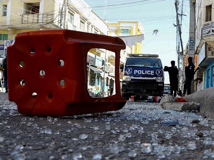 Somali police officers stand guard at the scene after an explosion at the Bakara market in Mogadishu, on February 6, 2024. 
