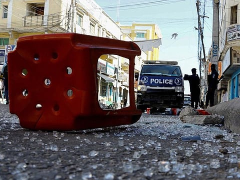 Somali police officers stand guard at the scene after an explosion at the Bakara market in Mogadishu, on February 6, 2024. 