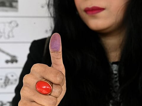 A woman casts her ballot at a polling station in Islamabad on February 8, 2024.  