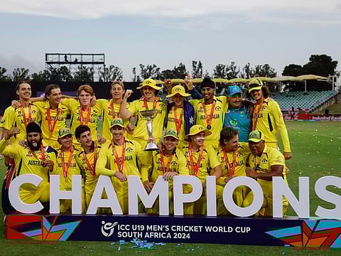 Australia players pose with the trophy after winning the Under-19 World Cup ODI final against India at Willowmoore Park in Benoni on Sunday.