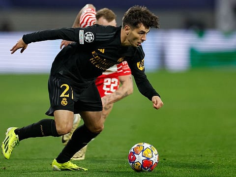 Real Madrid's Spanish forward Brahim Diaz (front) gets away from Leipzig's German midfielder David Raum during the Uefa Champions League Round of 16, first-leg football match in Leipzig, eastern Germany, on Tuesday.