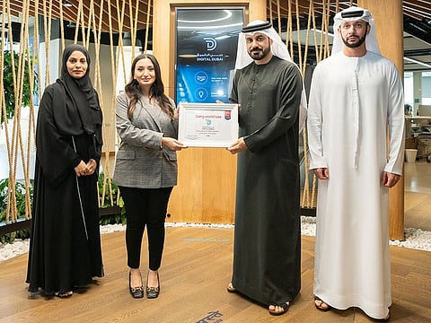 Tariq Al Janahi, Chief Executive Officer of the Corporate Enablement Sector at Digital Dubai (2nd R), receiving award from Rawan Wehbe, Regional Customer Relationship Manager, Great Place to Work® 