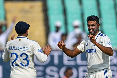 India's Ravichandran Ashwin (right) celebrates with teammate Kuldeep Yadav after taking his 500th wicket.