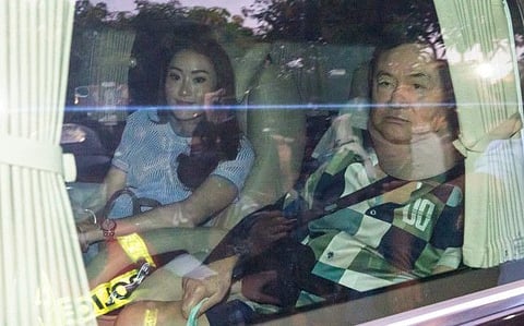 Former Thai Prime Minister Thaksin Shinawatra sits in a vehicle with his daughter Paetongtarn in front of his residence after being released on parole, on February 18, 2024, in Bangkok.
