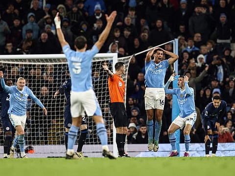 (From left) Manchester City's Norwegian striker Erling Haaland, defender Ruben Dias, midfielder Rodri and midfielder Phil Foden react as they argue with the referee during the English Premier League football match against Chelsea at the Etihad Stadium in Manchester, north west England, on February 17.