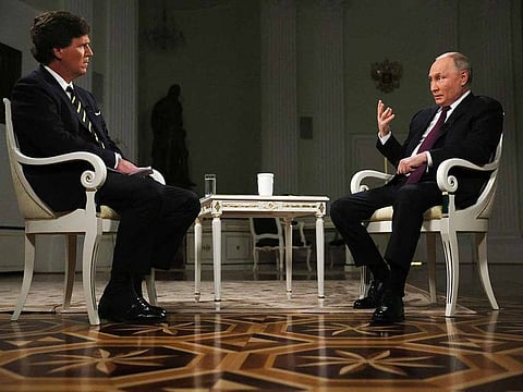 In this photo released by Sputnik news agency on Friday, Feb. 9, 2024, Russian President Vladimir Putin, right, gestures as he speaks during an interview with former Fox News host Tucker Carlson at the Kremlin in Moscow, Russia, Tuesday, Feb. 6, 2024. 