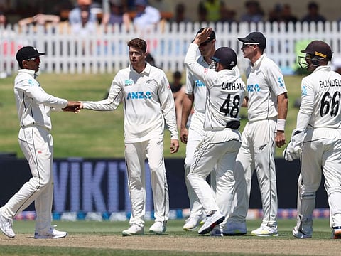 New Zealands Mitchell Santner (centre) celebrates the wicket of South Africas Clyde Fortuin during the first Test at the Bay Oval in Mount Maunganui on February 6.