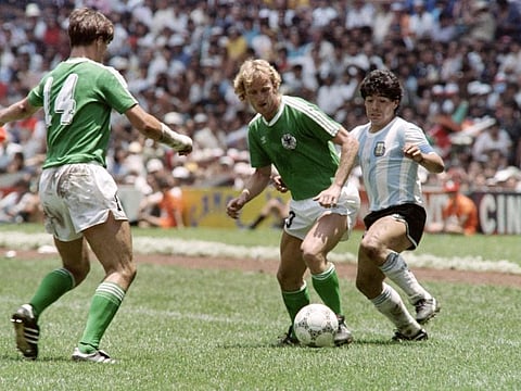 Argentina's Diego Maradona (right) fights for the ball with German Andreas Brehme (centre) and his teammate Thomas Berthold during the final of the 1986 Football World Cup on June 29, 1986 at Mexico City.