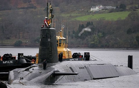 File picture: Crew from HMS Vengeance, a British Royal Navy Vanguard class Trident Ballistic Missile Submarine, stand on their vessel as they return along the Clyde river to the Faslane naval base near Glasgow.
