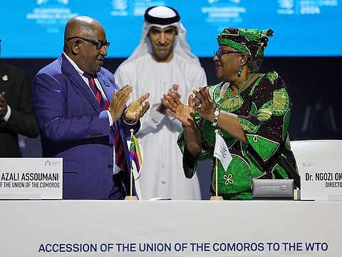 Director-General of the World Trade Organization (WTO) Ngozi Okonjo-Iweala, President of Comoros Azali Assoumani, and UAE Minister of State for Foreign Trade Thani bin Ahmed Al Zeyoudi chat after signing the agreement for the Comoros accession to the WTO during the 13th WTO Ministerial Conference in Abu Dhabi of February 26. 