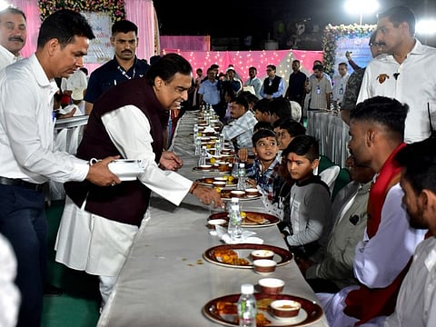 Mukesh Ambani, Chairman of Reliance Industries, serves traditional Gujarati food to villagers ahead of his son Anant Ambani's pre-wedding celebrations on the outskirts of Jamnagar, Gujarat, on February 28, 2024.  
