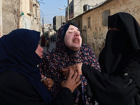 Rania Abu Anza (centre), the mother of twin babies Naeem and Wissam, killed in an overnight Israeli air strike, ahead of their burial in Rafah in the southern Gaza Strip on March 3, 2024.  