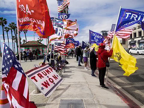 Supporters of Republican presidential candidate and former US President Donald Trump gather, ahead of Super Tuesday, in Huntington Beach, California, on March 3, 2024.  
