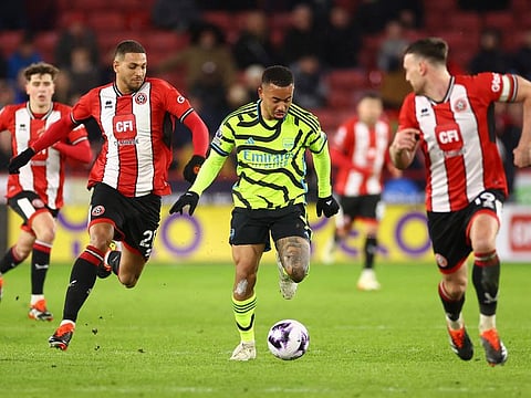 Arsenal's Gabriel Jesus in action with Sheffield United's Vinicius Souza and Jack Robinson during a Premier League match.
