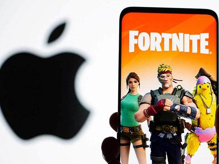 File photo: Fortnite game graphic is displayed on a smartphone in front of Apple logo in this illustration. 