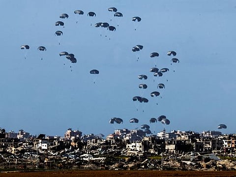 Packages fall towards northern Gaza, after being dropped from a military aircraft, amid the ongoing conflict between Israel and the Palestinian group Hamas in southern Israel March 7, 2024. 
