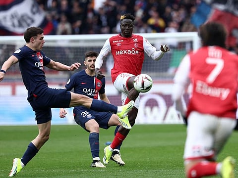 Paris Saint-Germain's midfielder Manuel Ugarte (left) fights for the ball with Reims' Ivorian forward Oumar Diakite during the L1 football match at the Parc des Princes stadium in Paris on Sunday.