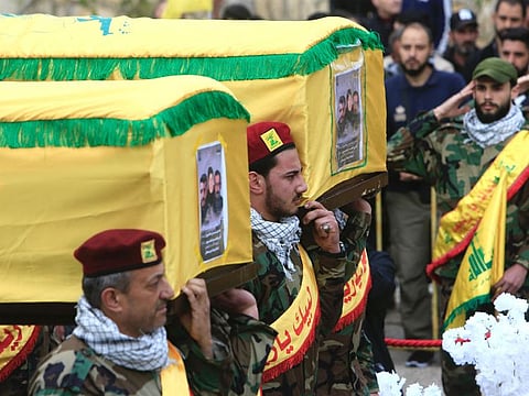 Hezbollah militants and supporters attend the funeral of one of the group's members Hassan Hussein, his wife Ruwaida Mustafa, and their 25-year-old son Ali Hussein, killed in Israeli bombardment, during their funeral in their southern Lebanese village of Houla on March 6, 2024.