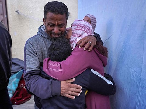 Palestinians mourn the death of a family member in the courtyard of the Al Aqsa Martyrs Hospital in Deir Al Balah in the central Gaza Strip, after he was killed in Israeli strikes on the makeshift Al Mawasi camp for displaced people west of Khan Younis on March 10, 2024. 