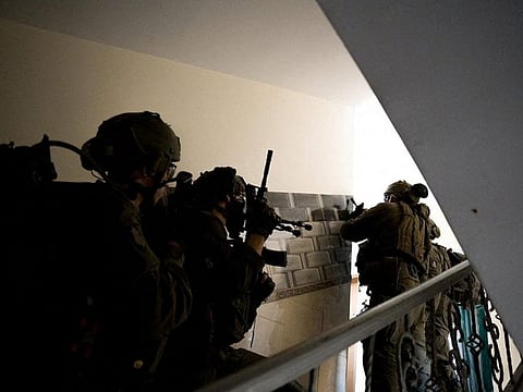 Israeli soldiers operate in the Gaza Strip amid the ongoing conflict between Israel and the Palestinian Islamist group Hamas, in this handout picture released on March 11, 2024.  