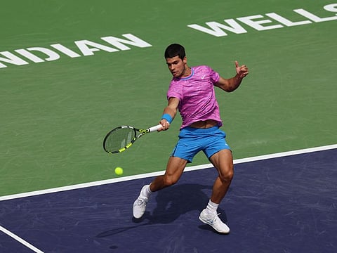 Carlos Alcaraz of Spain plays a forehand against Felix Auger-Aliassime of Canada in their third round match during the BNP Paribas Open at Indian Wells Tennis Garden on Sunday.