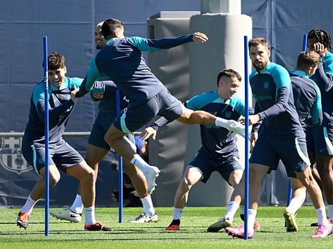 Barcelona's players attend a training session on the eve of their Uefa Champions League last 16 second leg football match against SSC Napoli at the training centre in Barcelona on Monday.