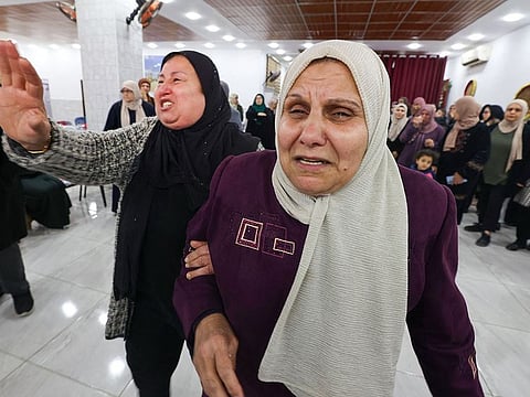  Relatives of Mahmud Abu Alheja, one of the two Palestinian youths who were killed during an Israeli army raid the previous day in Jenin, in the occupied West Bank, react during  their funeral on March 13, 2024.   
