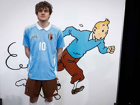 A model presents the Belgian football team's new away jersey paying tribute to Belgian comics series character Tintin at the Herge Museum in Louvain-La-Neuve on March 14, 2024.