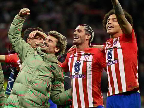 Atletico Madrid's forward Antoine Griezmann, midfielder Rodrigo De Paul and midfielder Axel Witsel celebrate victory at the end of the Uefa Champions League last 16 second leg football match against Inter Milan at the Metropolitano stadium in Madrid on Wednesday..