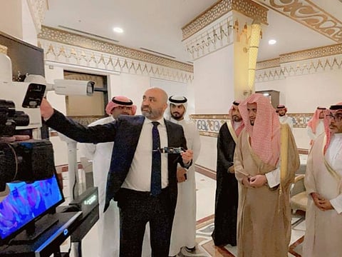 Saudi Attorney General Saud bin Abdullah Al Mojeb (centre) listens to briefing about the device in Mecca.
