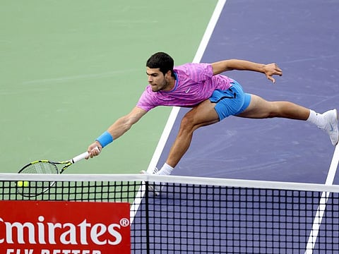 Carlos Alcaraz of Spain returns a shot to Jannik Sinner of Italy during the semi-finals of the BNP Paribas Open at Indian Wells Tennis Garden on Saturday.