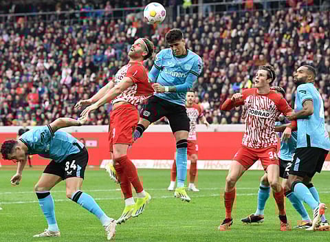 Bayer Leverkusen's midfielder Granit Xhaka, forward Patrik Schick, Freiburg's forward Lucas Hoeler and Freiburg's midfielder Merlin Roehl vie for the ball during the German first division Bundesliga football match on Sunday.
