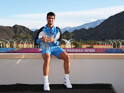 Carlos Alcaraz of Spain with the trophy at the media photocall after his straight sets victory against Daniil Medvedev in the men's final of the BNP Paribas Open at Indian Wells Tennis Garden on Sunday.